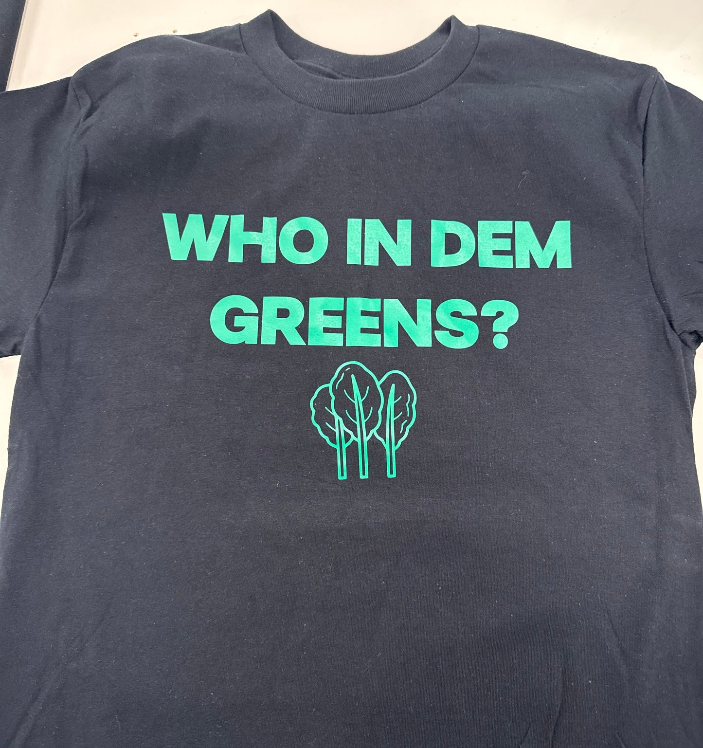“Who In Dem Greens?” Tees